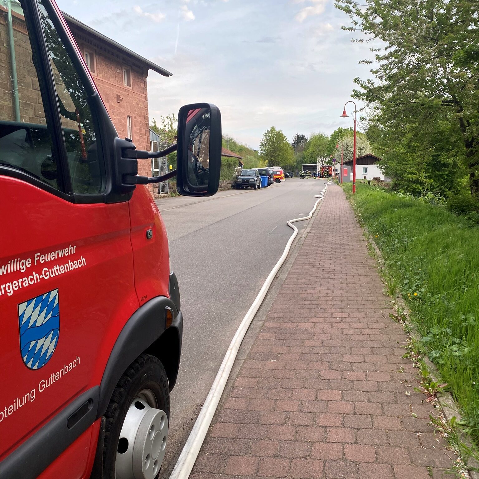 Eine lange Schlauchleitung liegt auf der Straße.